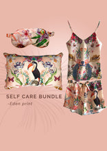Load image into Gallery viewer, Luxury self-care gift bundle: Coral coloured silk pyjama set, pillowcase and eye mask in &#39;Eden&#39; Print