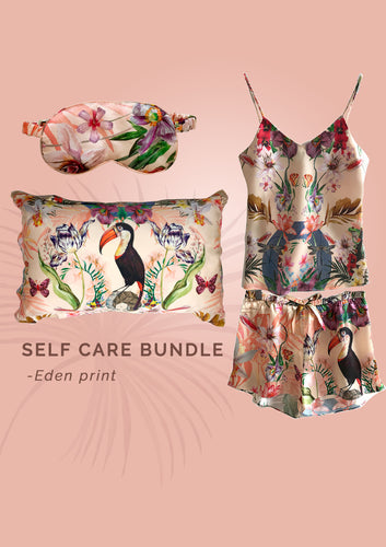 Luxury self-care gift bundle: Coral coloured silk pyjama set, pillowcase and eye mask in 'Eden' Print