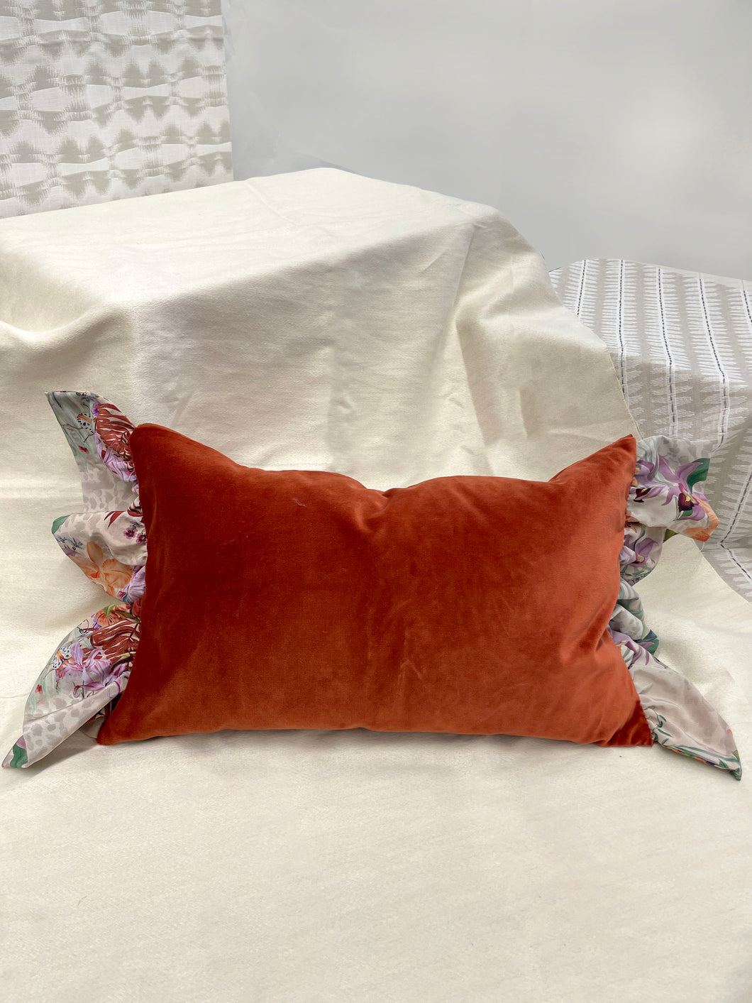 Rust colour velvet rectangular cushion with silk frill trim
